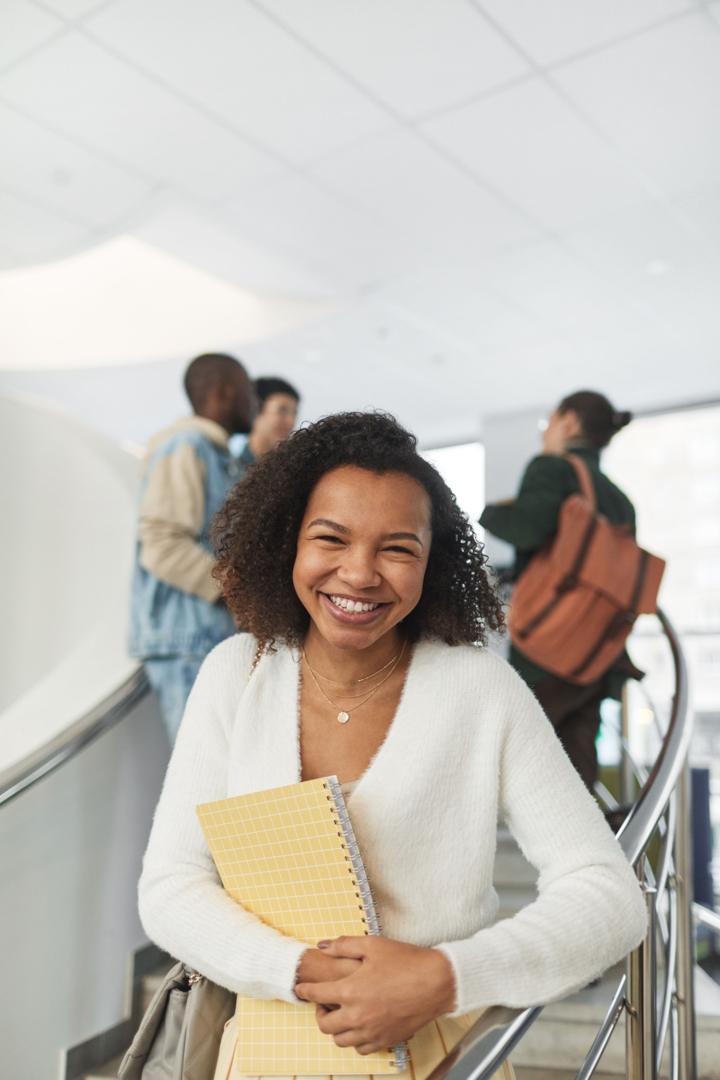 Smiling student on a university staircase
